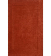 Solid terracotta orange hand-tufted wool rug with embossed rectangle